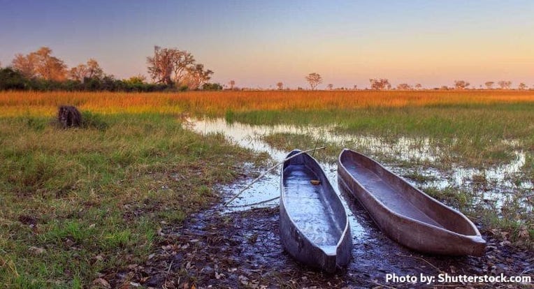 Two canoes on mudflats