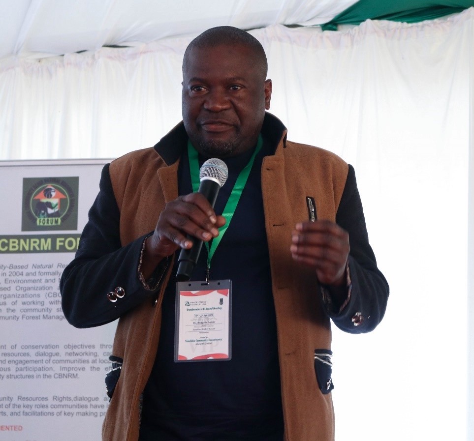 Front view of a man speaking into a microphone.