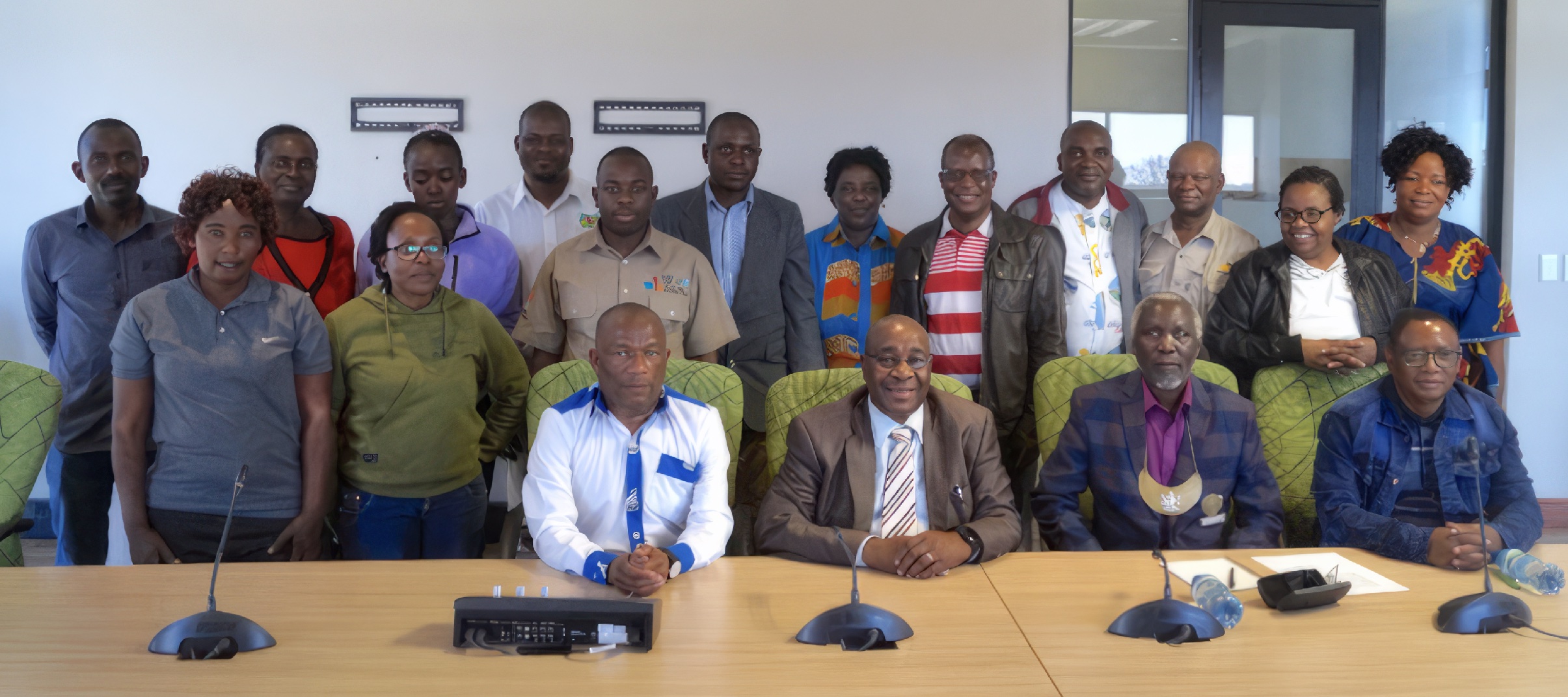 A group of delegates pose in a conference room.
