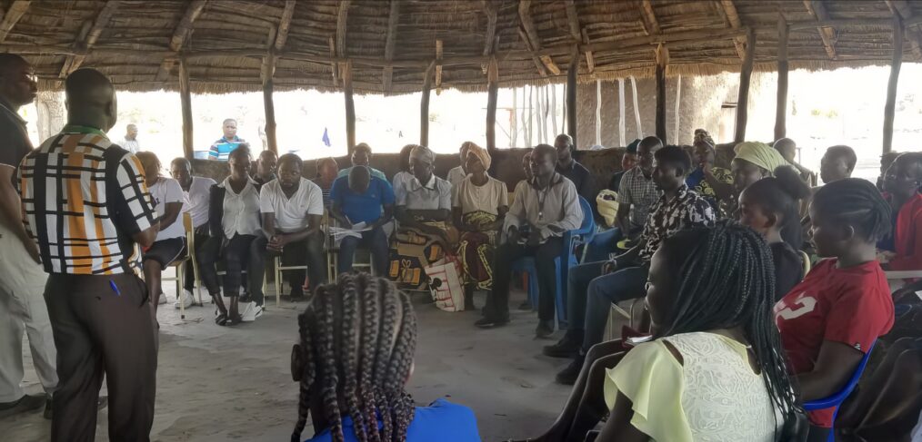 A group of people sitting in a circular meeting building.