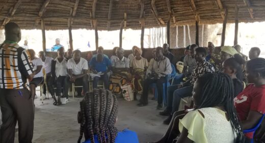 A group of people sitting in a circular meeting building.