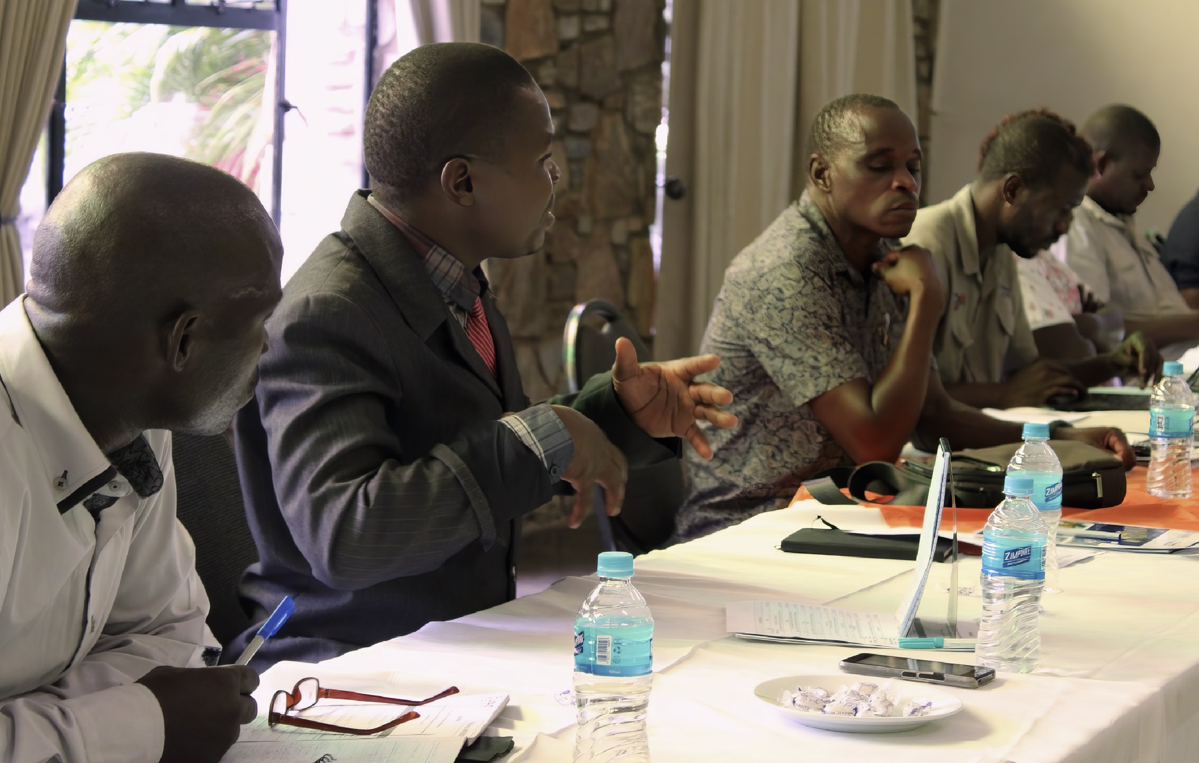 Five men sitting at a conference table.
