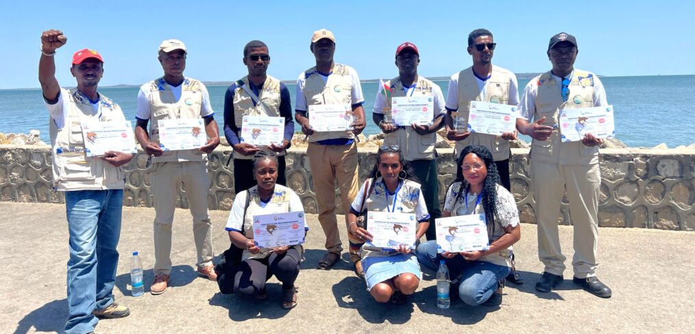 Ten people posing with certificates.