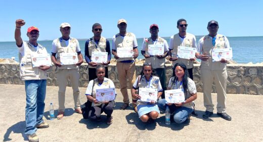 Ten people posing with certificates.