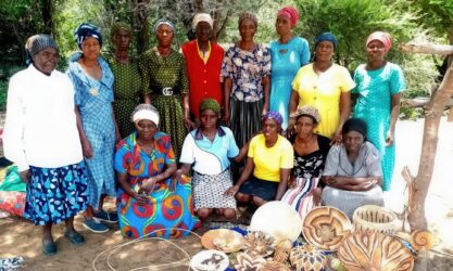 Fourteen ladies post with a collection of hand-woven baskets.